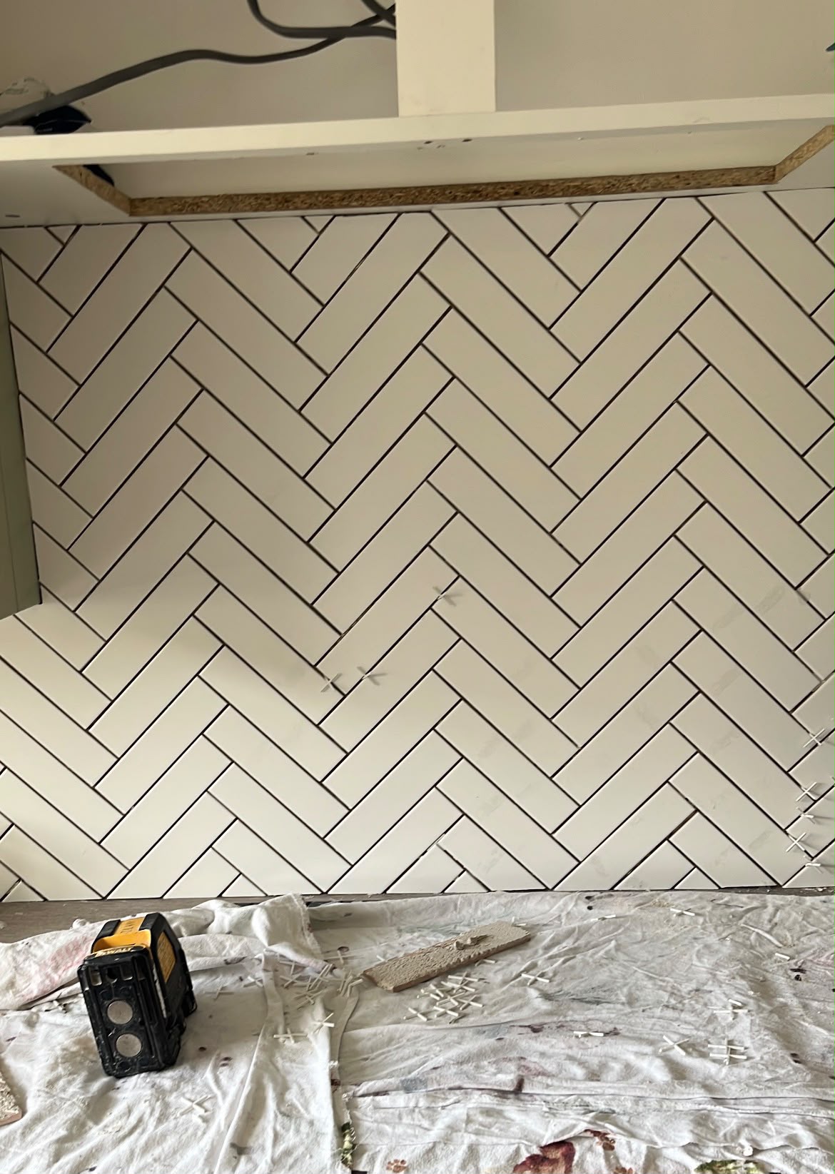 White herringbone metro tile kitchen splashback